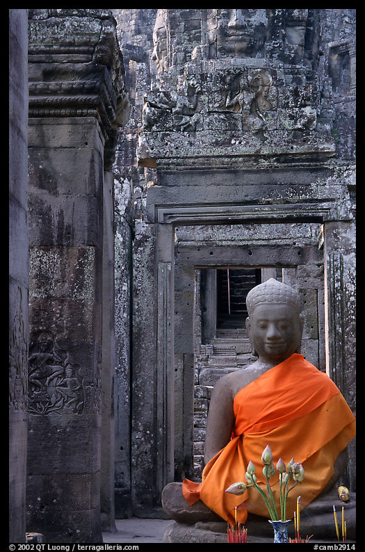 Buddha image, swathed in reverence, with offerings, the Bayon. Angkor, Cambodia