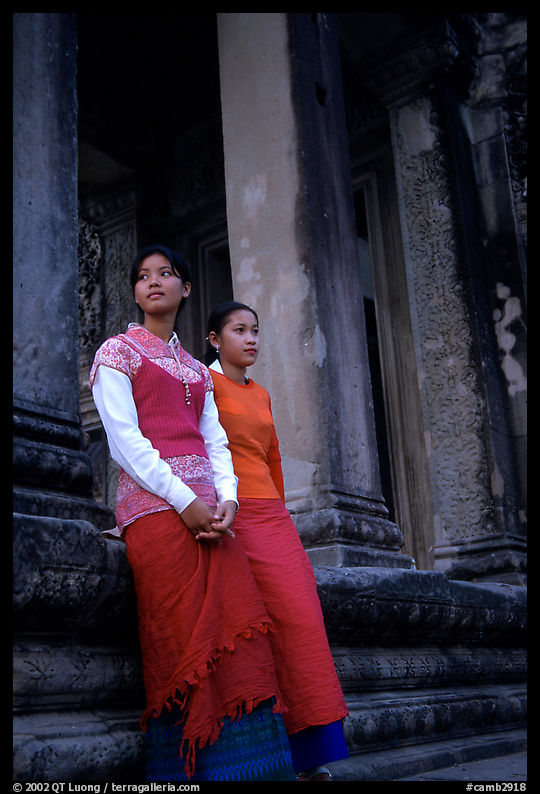 Elegant young women near the temple entrance. Angkor, Cambodia