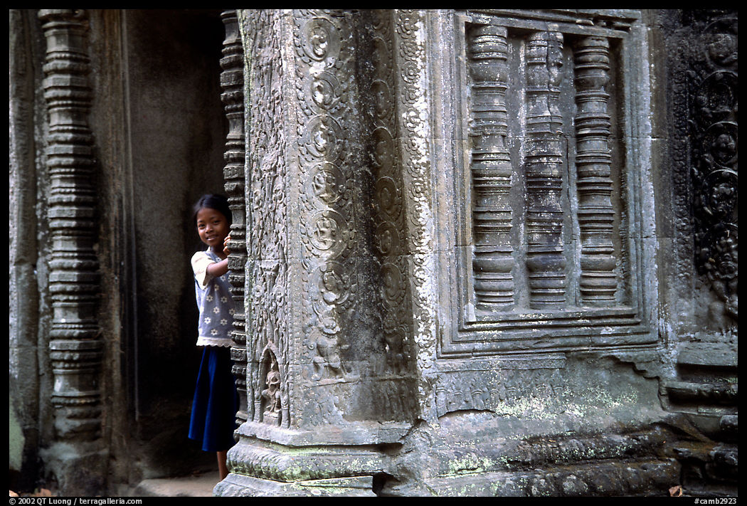Girl hides in Ta Prom. Angkor, Cambodia