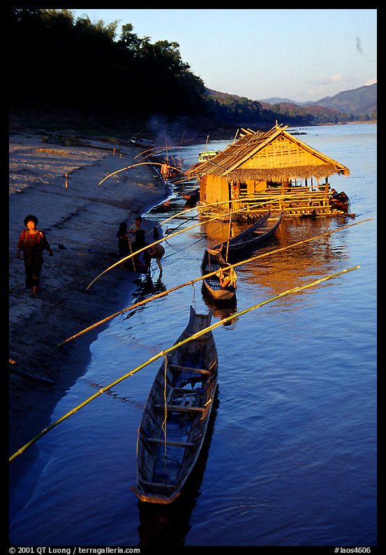 Boats and stilt house of a small hamlet. Mekong river, Laos