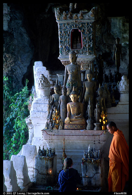 Novice Buddhist monk and vistor in Pak Ou cave. Laos