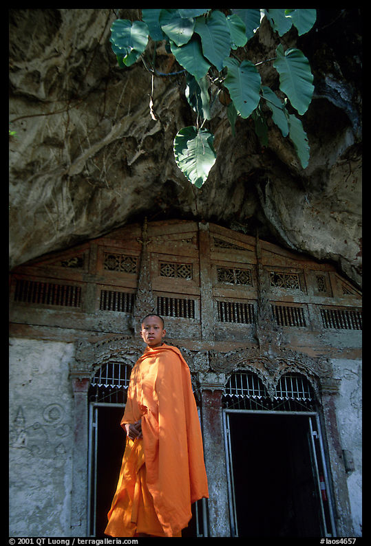 Novice Buddhist monk at entrance of Pak Ou cave. Laos