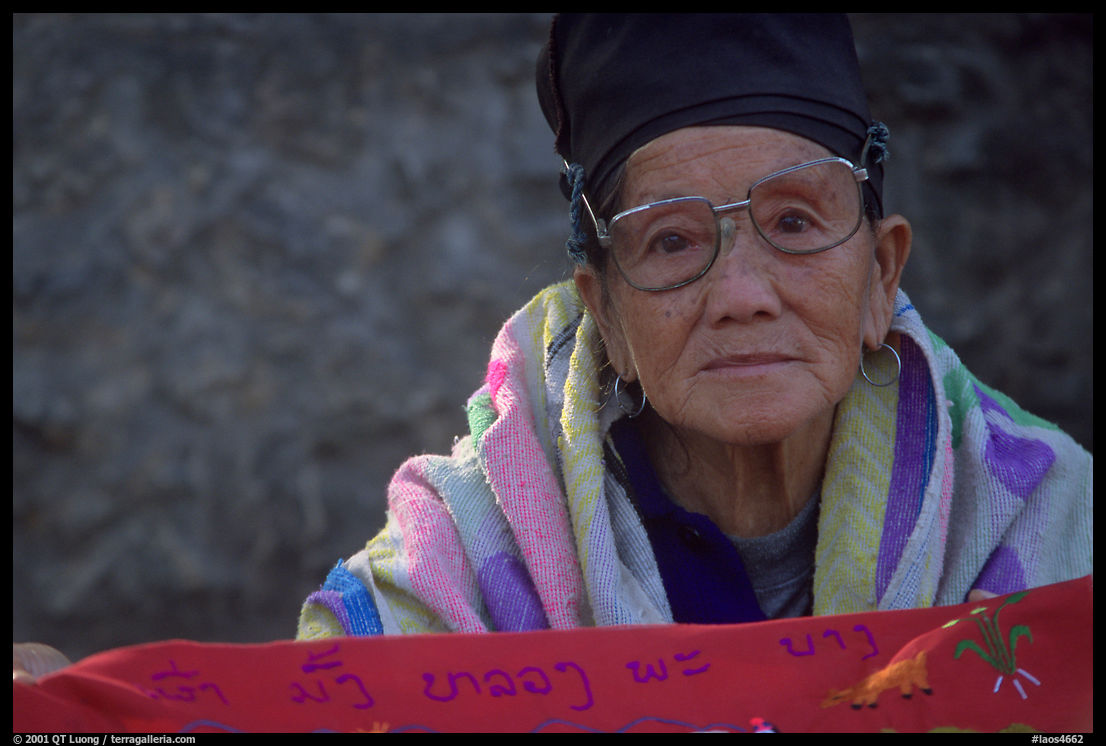 Older woman wears a mix of tribal and western garb. Luang Prabang, Laos
