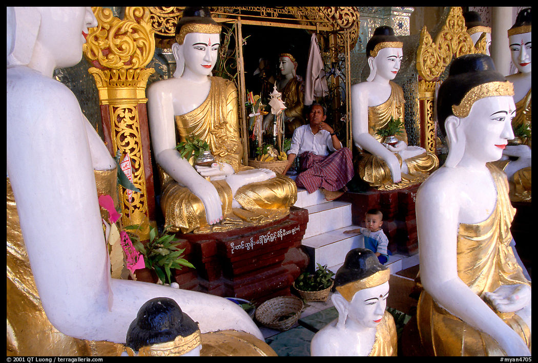 Surrounded by Buddha statues, Shwedagon Paya. Yangon, Myanmar