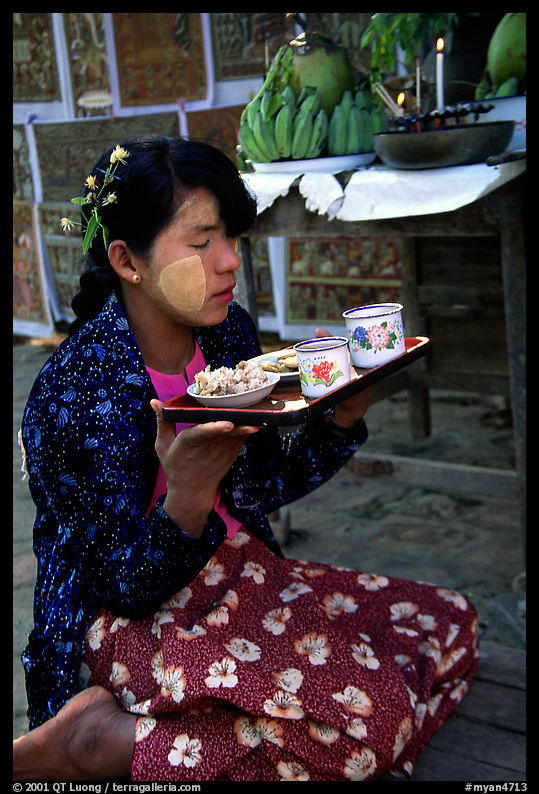 Burmese woman offering food. Bagan, Myanmar
