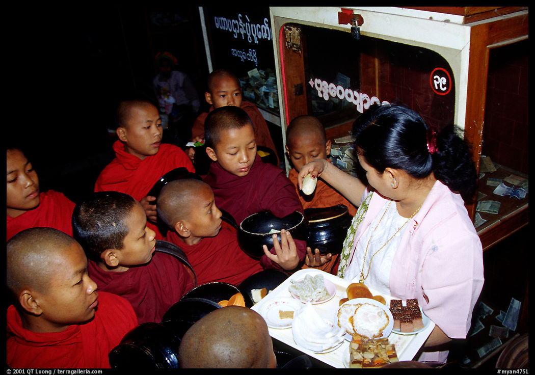 Novice during alm round at Mahamuni Paya. Mandalay, Myanmar
