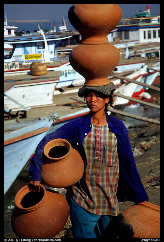 Carrying many jars. Mandalay, Myanmar