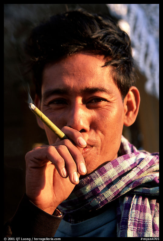 Man enjoying a cheerot (burmese cigar). Mandalay, Myanmar