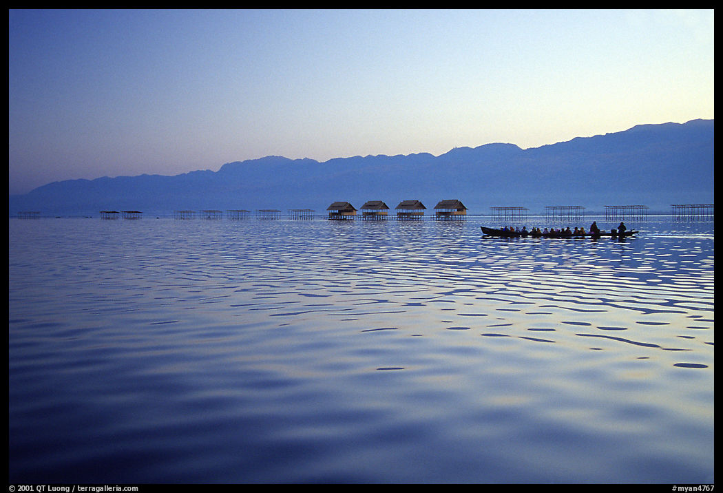 Long boat,  stilts huts, and mountains, sunrise. Inle Lake, Myanmar