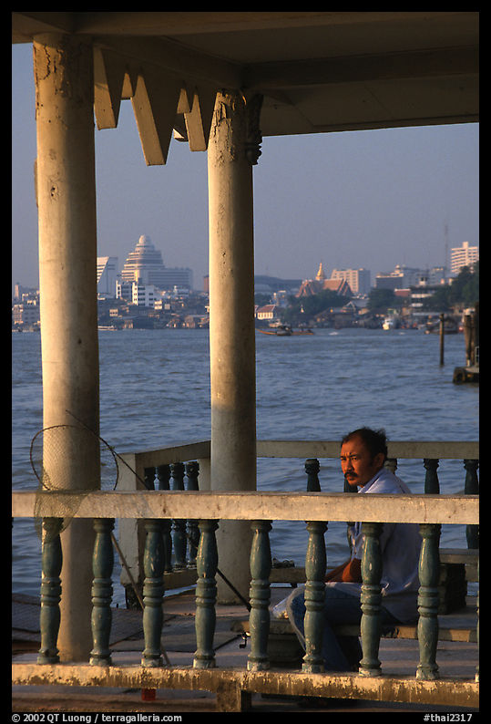 Man fishing on the Chao Phraya river. Bangkok, Thailand