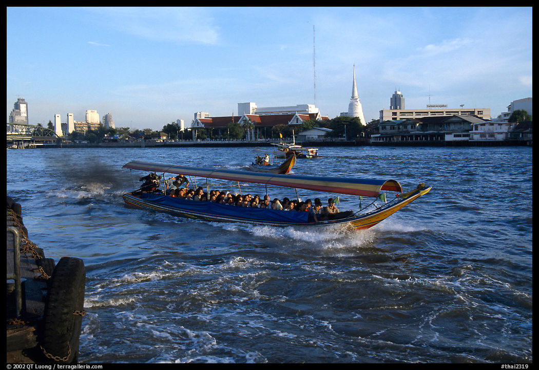 Crowded long tail taxi boat on the Chao Phraya river. Bangkok, Thailand