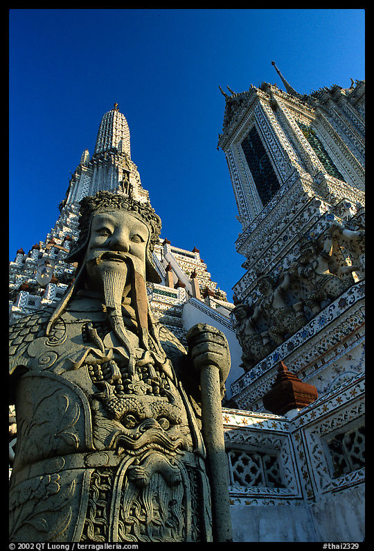 Statue and tower, Wat Arun. Bangkok, Thailand