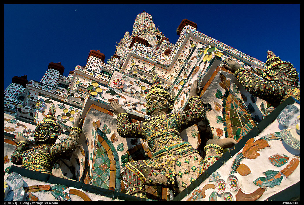 Statues at the base of the prang, Wat Arun. Bangkok, Thailand
