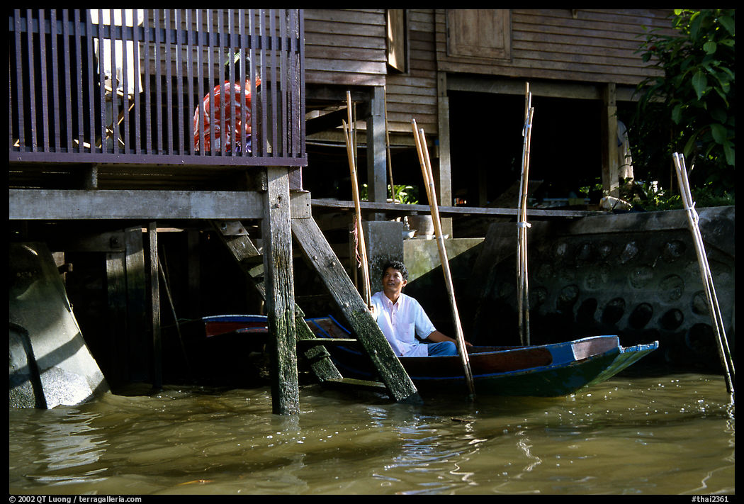 Conversation with a neighbor along a khlong on Thonbury canals. Bangkok, Thailand