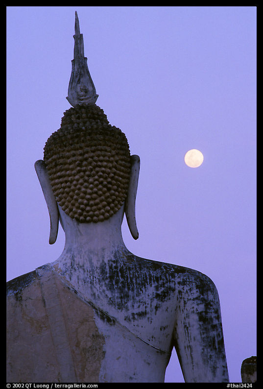 Moon and buddha image at dusk, Wat Mahathat. Sukothai, Thailand