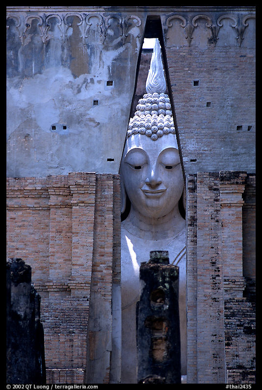 Monumental Buddha image seen between walls,  Wat Si Chum. Sukothai, Thailand