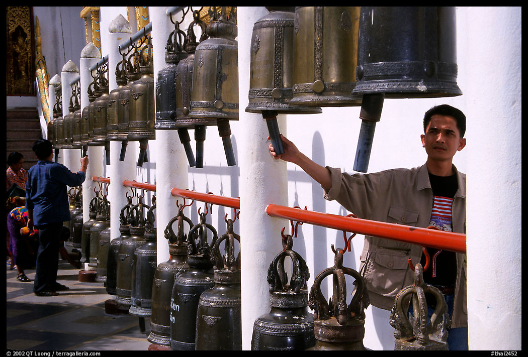 Worshiper rings bells at Wat Phra That Doi Suthep. Chiang Mai area, Thailand