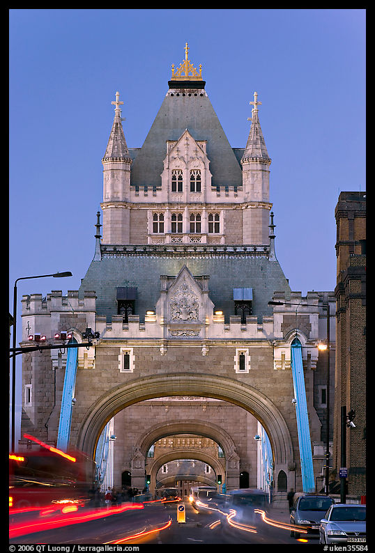 Traffic under arches of the Tower Bridge at twilight. London, England, United Kingdom