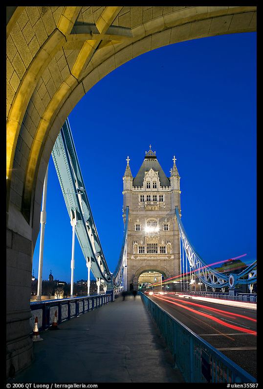 Walkway and road traffic on the Tower Bridge at night. London, England, United Kingdom