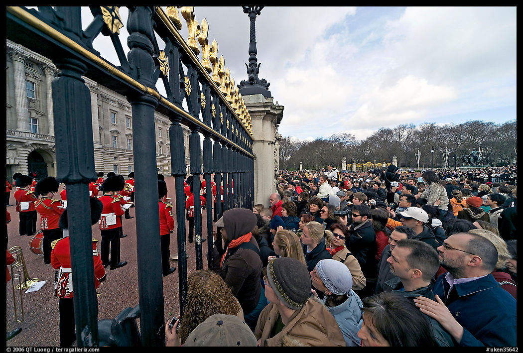Crowds at the grids in front of Buckingham Palace watching the changing of the guard. London, England, United Kingdom