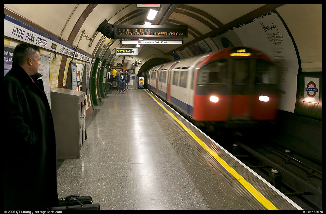 Man waiting for approaching train at Hyde Park subway station. London, England, United Kingdom