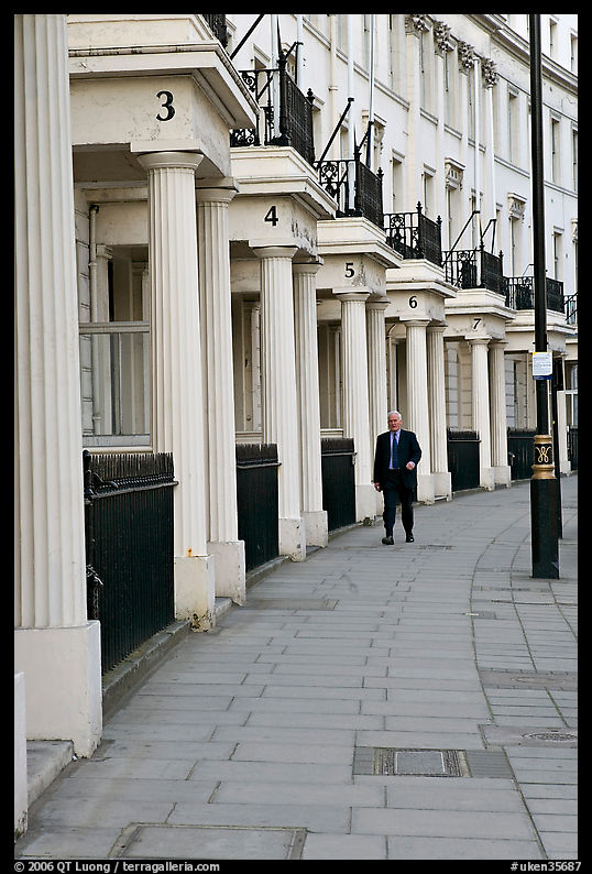 Businessman walking down near townhouses crescent. London, England, United Kingdom