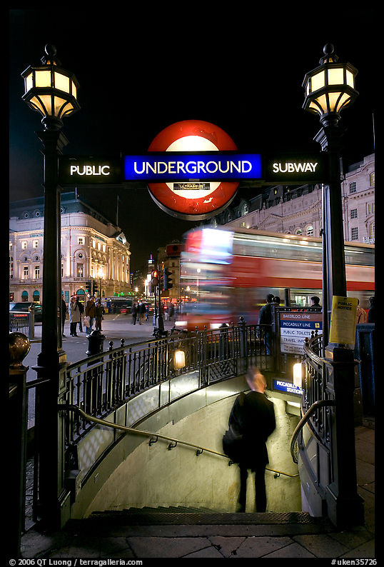 Man entering underground, and motion-blurred double decker bus,  Piccadilly Circus. London, England, United Kingdom