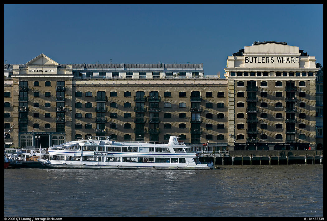 Butler Wharf and tour boat on the Thames. London, England, United Kingdom