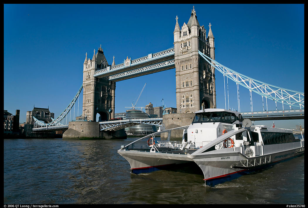 Fast catamaran cruising the Thames, with Tower Bridge in the background. London, England, United Kingdom