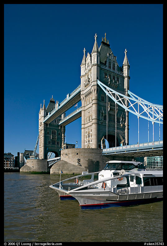 Catamaran below Tower Bridge. London, England, United Kingdom