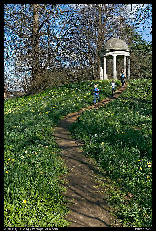 Children running down a trail leading to gazebo. Kew Royal Botanical Gardens,  London, England, United Kingdom
