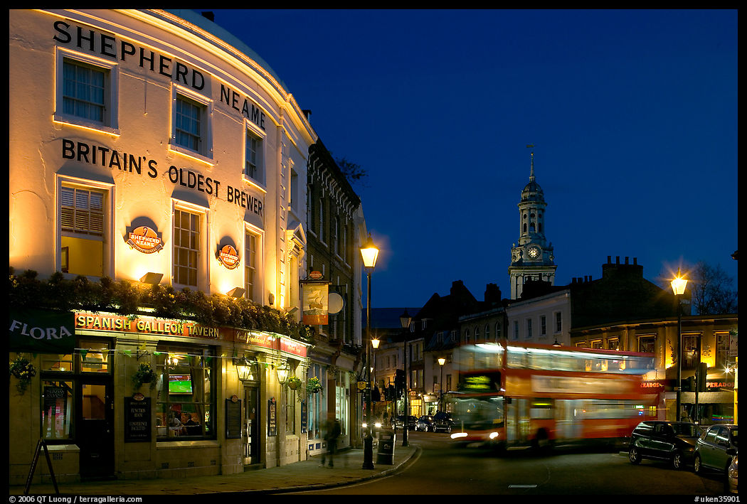 Tavern, moving double decker bus, and church at night. Greenwich, London, England, United Kingdom