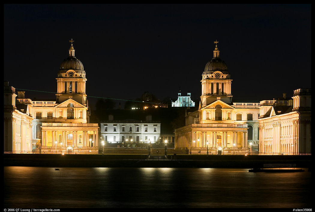 Old Royal Naval College, Queen's house, and Royal observatory with laser marking the Prime meridian at night. Greenwich, London, England, United Kingdom