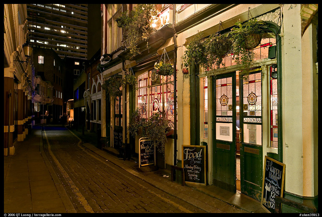 Saloon bar and cobblestone alley at night. London, England, United Kingdom