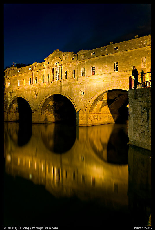 Man looking at the Pulteney Bridge  at night. Bath, Somerset, England, United Kingdom