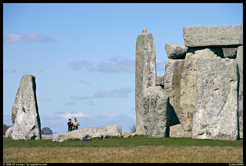 Couple looking at the standing stones, Stonehenge, Salisbury. England, United Kingdom