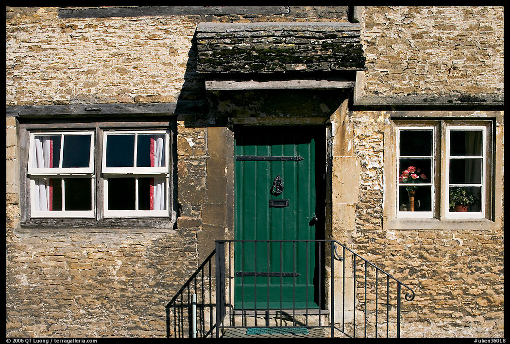 Windows and doorway entrance of stone house, Lacock. Wiltshire, England, United Kingdom