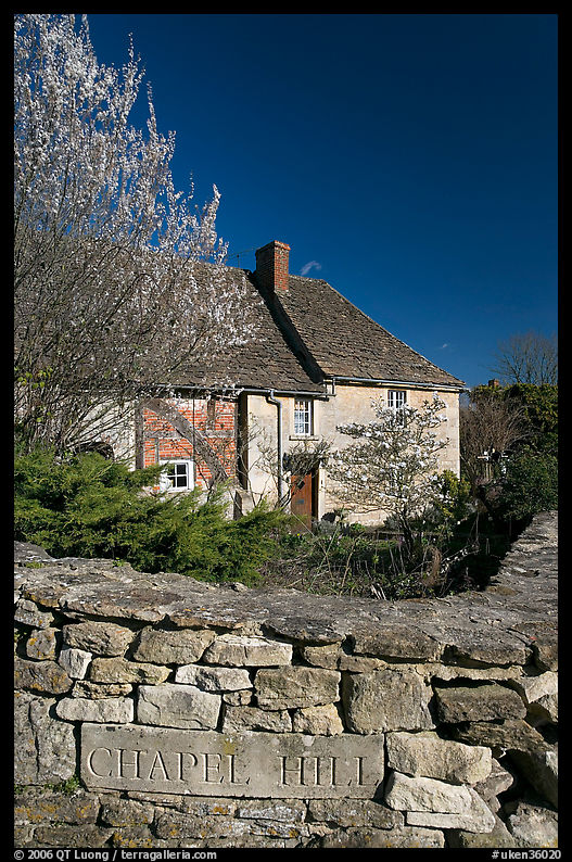 Stone wall with engraved street name, yard and house, Lacock. Wiltshire, England, United Kingdom
