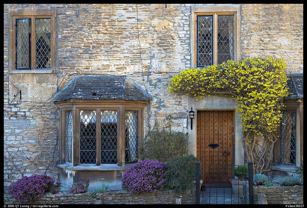 Stone house facade with flowers, Castle Combe. Wiltshire, England, United Kingdom