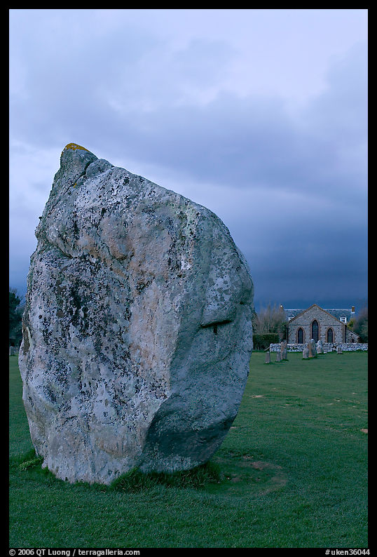 Standing stone and chapel at dusk, Avebury, Wiltshire. England, United Kingdom