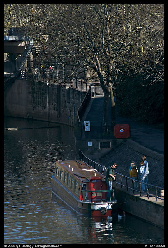 Family stepping out of houseboat onto quay. Bath, Somerset, England, United Kingdom