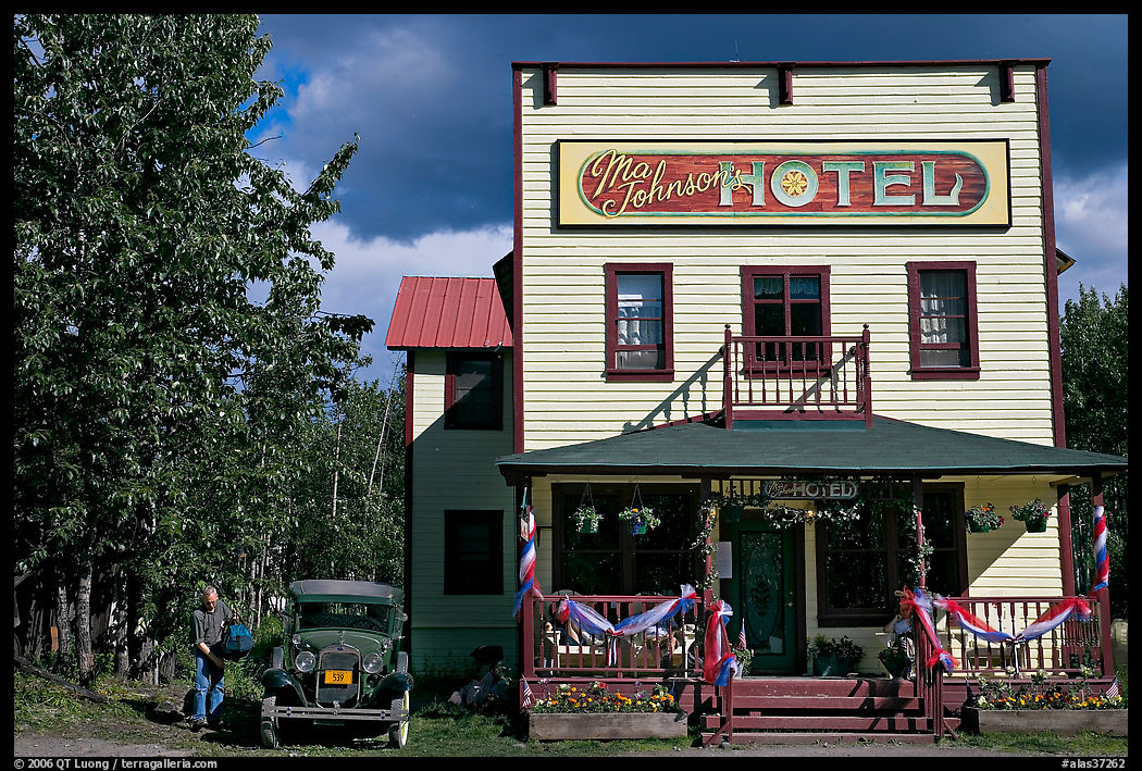 Small hotel with classic car parked by, afternoon. McCarthy, USA