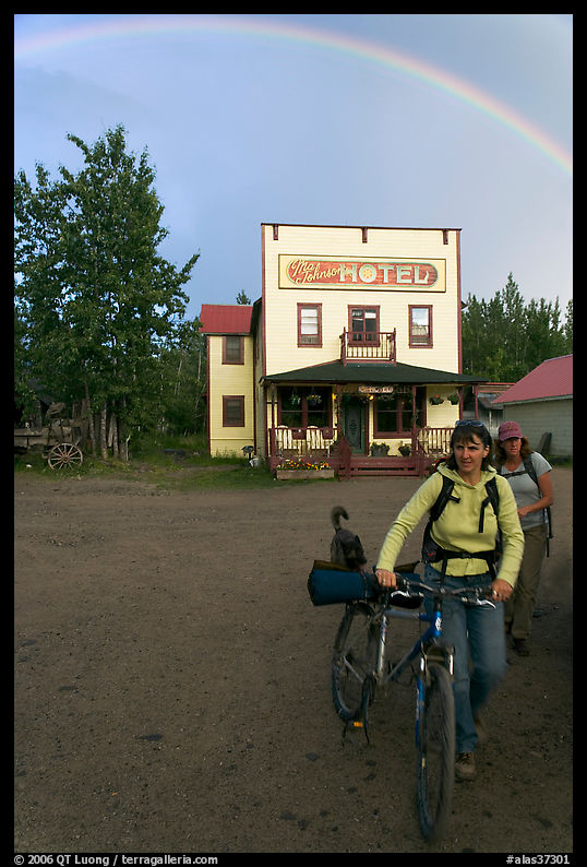 Women with bikes, hotel, and rainbow. McCarthy, USA