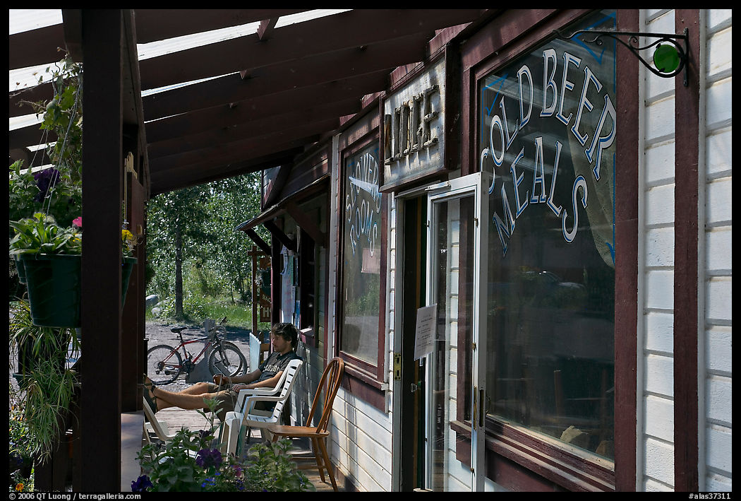 Man sitting in front of McCarthy lodge. McCarthy, USA