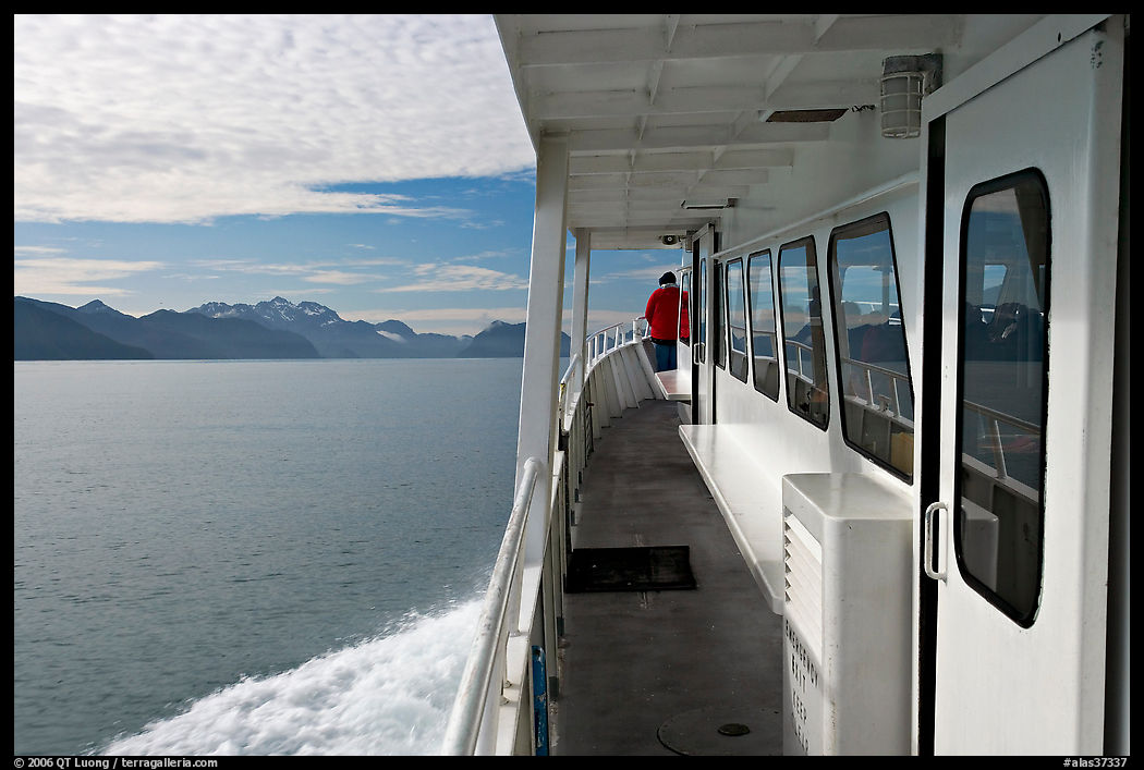 Passenger standing outside tour boat. Seward, Kenai Peninsula, Alaska, USA