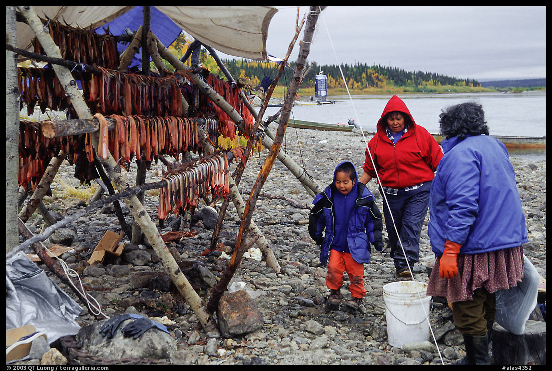 Inupiaq Eskimo family with stand of dried fish, Ambler. North Western Alaska, USA