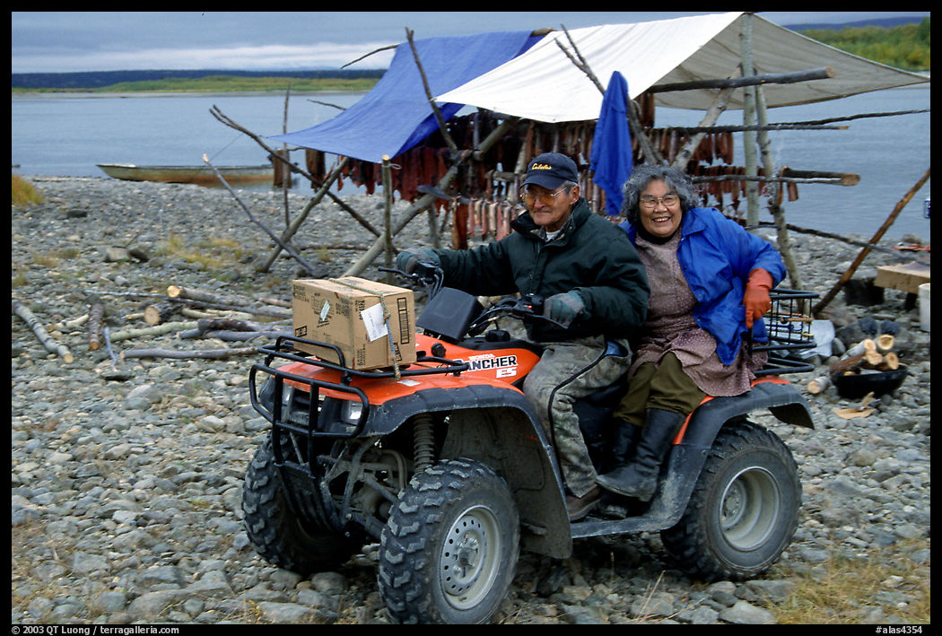 Inupiaq Eskimo man and woman riding on a four-wheeler, Ambler. North Western Alaska, USA