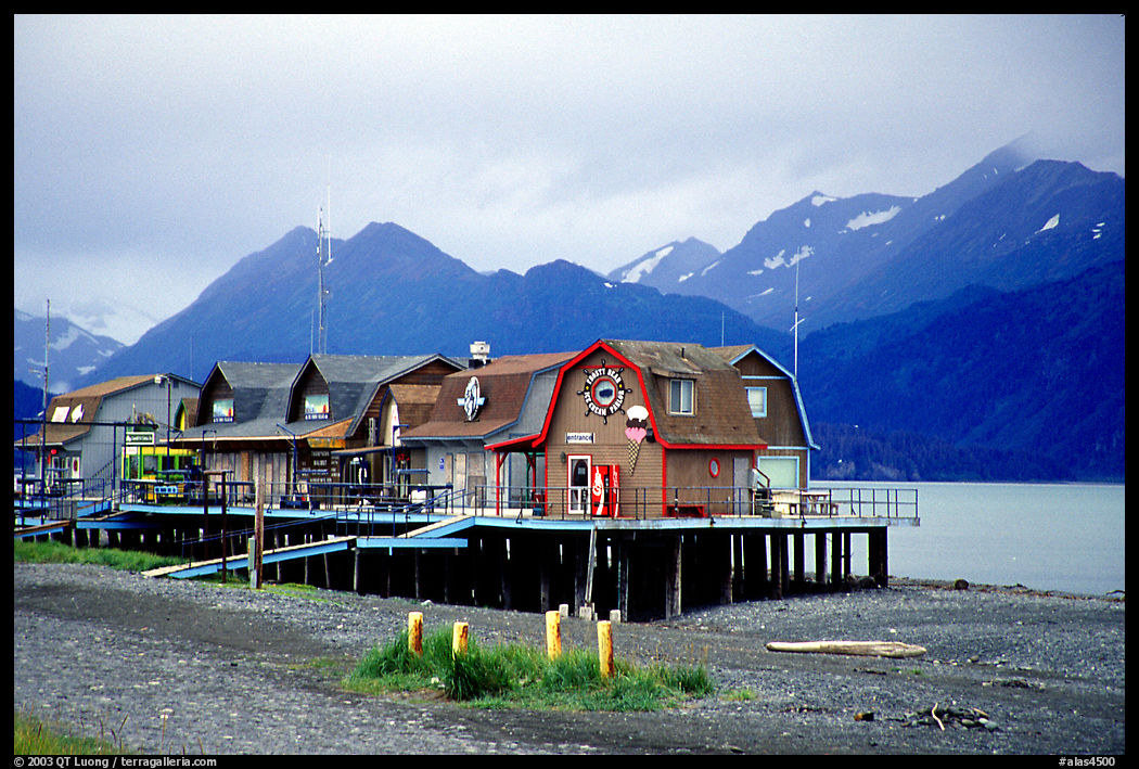 Stilt houses on the Spit, Kenai Mountains in the backgound. Homer, Kenai Peninsula, Alaska, USA