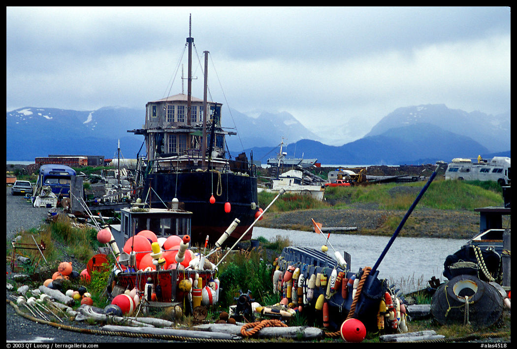 Retired fishing boat with a pile of marine gear on the Spit. Homer, Kenai Peninsula, Alaska, USA
