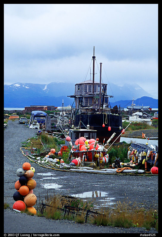 Retired fishing boat with a pile of marine gear on the Spit. Homer, Kenai Peninsula, Alaska, USA